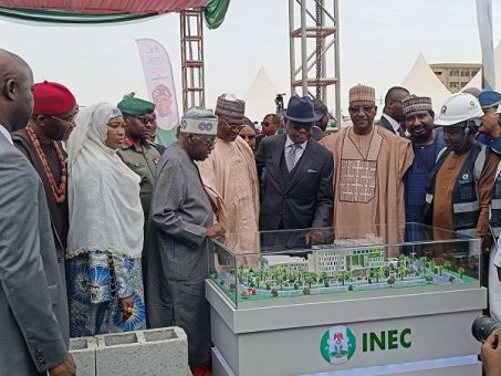 President Bola Tinubu admires the Artist impression of the new headquarters annex building of the Independent National Electoral Commission 453x340